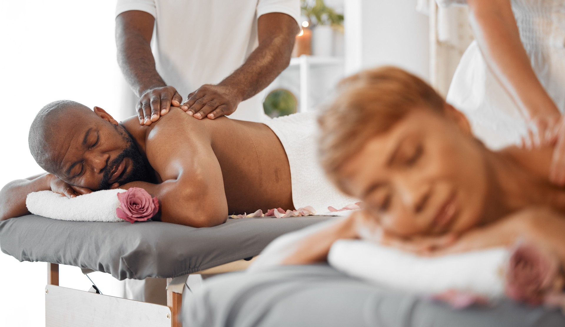 Black couple, massage in spa with massage therapist and wellness, romantic holiday for stress relief and body care. Beauty, calm and health with luxury service, aromatherapy and body wellbeing.